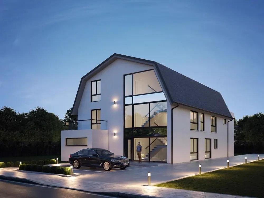 Dasselbe Haus fertiggestellt: helle Fassade, bodentiefe Fensterfront und beleuchteter Eingang am Abend