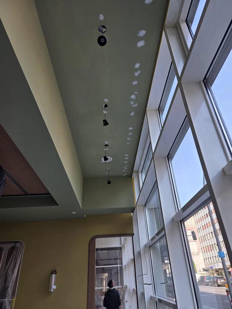 Abgehängte Decke mit Lichtvoute und eingebauten Spots an einer Fensterfront